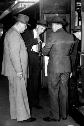 Detectives outside the carriage where Perkman's body was found. February 20, 1954