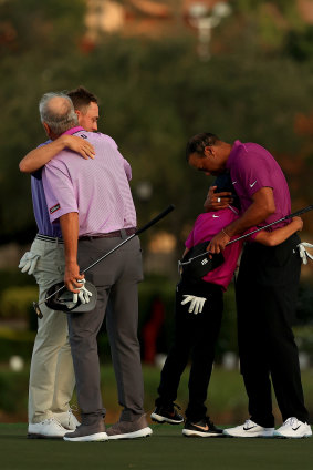 Tiger Woods of the United States hugs son Charlie Woods as  Justin Thomas of the United States hugs dad Mike Thomas on the 18th hole during the first round of the PNC Championship at the Ritz Carlton Golf Club on December 19, 2020 in Orlando, Florida.