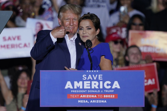 Former President Donald Trump embraces Arizona Republican gubernatorial candidate Kari Lake at a rally in Mesa, Arizona.