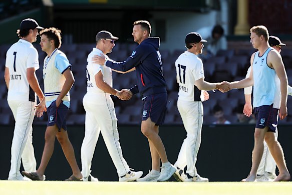 Josh Hazlewood shakes hands with Scott Boland after their Sheffield Shield match at the SCG. 