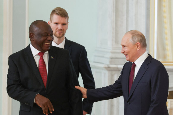 Russian President Vladimir Putin and South African President Cyril Ramaphosa react while speaking during their meeting following the Russia-Africa summit in Saint Petersburg on Saturday.