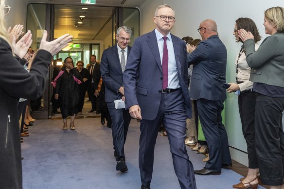 Staffers applaud the Minister for Indigenous Australians Linda Burney, Prime Minister Anthony Albanese and Attorney-General Mark Dreyfus after the emotional press conference in Canberra.