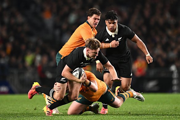 Jordie Barrett is tackled at Eden Park.