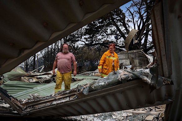 The Laherty-Hunts examine the damage at their property.