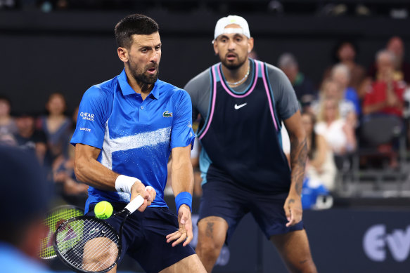 Novak Djokovic plays a forehand in the men’s doubles match partnered with Nick Kyrgios against Andreas Mies and Alexander Erler.