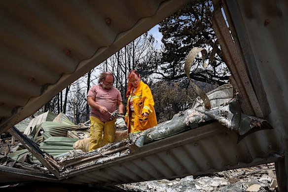 Jaime and Ann Laherty-Hunt at the remains of their property near Ruffy.