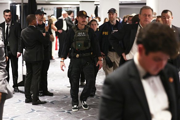 Law enforcement intervenes during an incident at the White House Correspondents' Dinner.