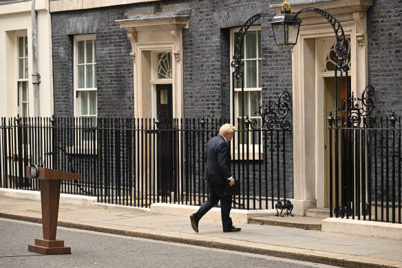 Boris Johnson leaves the lectern after announcing his resignation.