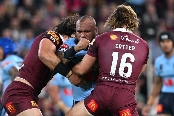 Reuben Cotter and Tino Fa’asuamaleaui get in the face of Junior Paulo during Origin II at Suncorp Stadium.