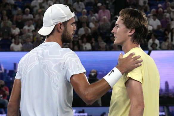 Karen Khachanov of Russia, left, consoles Sebastian Korda of the US after Korda withdrew from their quarterfinal match with an injured wrist.
