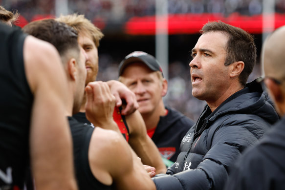 Firefighters coach Brad Scott addresses his charges at quarter time.