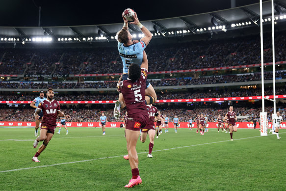 Zac Lomax soars over Murray Taulagi to score his first try of the night.