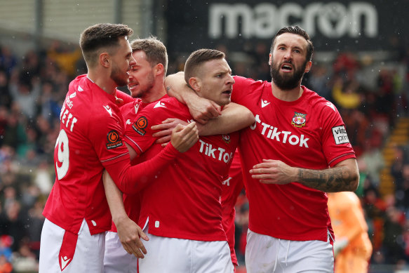 Paul Mullin and Ollie Palmer (second right and right) celebrate Wrexham’s opener in the crucial National League showdown against Notts County.