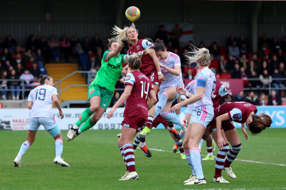 Mackenzie Arnold attempts to clear the ball for West Ham.