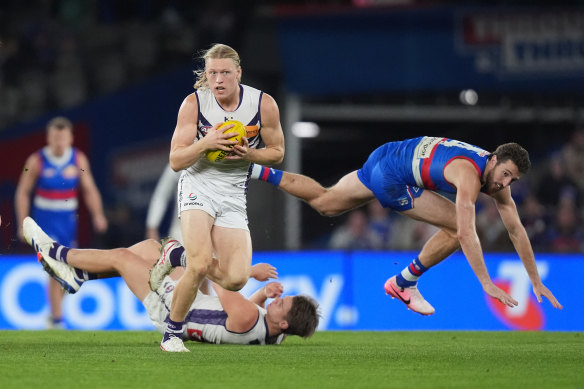 Hayden Young of the Dockers runs with the ball.