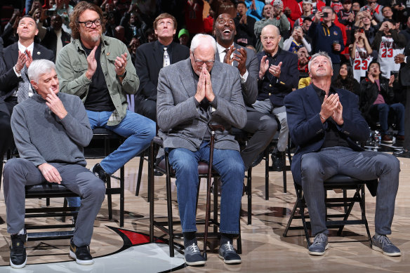 Legendary Bulls coach Phil Jackson takes the applause as Longley looks on.