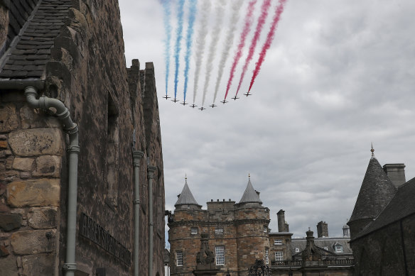 The Royal Airforce Red Arrows fly past over Holyroodhouse.
