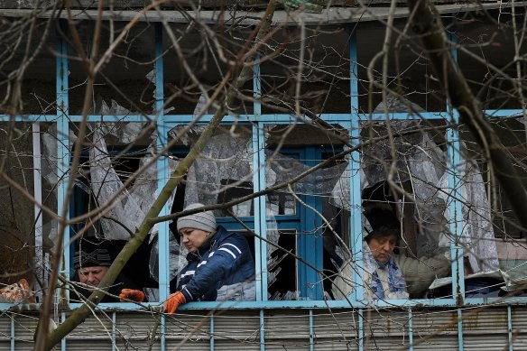 Residents clean up the damage from a missile attack in Kramatorsk.