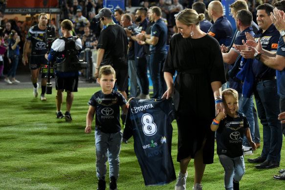 Matt Scott’s family - sons Hugo and Will, and wife Lauren - carry his jersey at what was supposed to be his final game in Townsville.