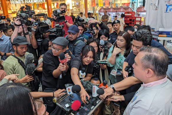 Malaysia’s Transport Minister Anthony Loke, right, addresses reporters on Sunday. 