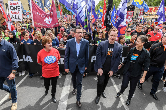 Lisa Fitzpatrick from the ANMF, Premier Daniel Andrews, Luke Hilakari from Trades Hall and ACTU secretary Sally McManus march together in Melbourne in 2018.