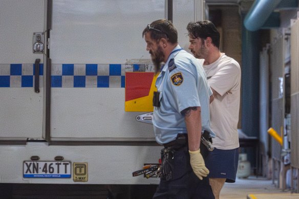 Benjamin David Collinge being transported from Burwood Local Court. The teacher has been charged with grooming a 14-year-old girl online.