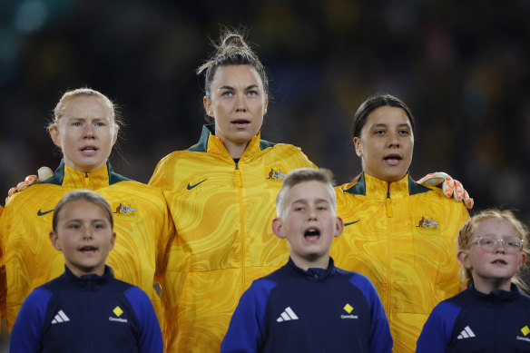 Australia’s Clare Polkinghorne, Mackenzie Arnold and Sam Kerr line up during the national anthems.