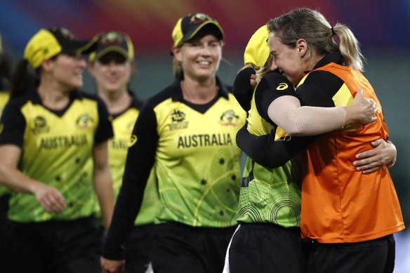 An emotional Ellyse Perry embraces her victorious teammates after their World Cup semi-final win.