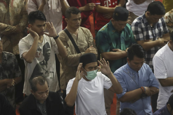 A man wears a mask during Friday prayers in Indonesia, despite claims the coronavirus is not present in the country.