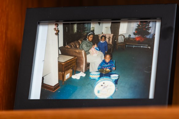 Joshua Jones playing drums as a child in a family photo.