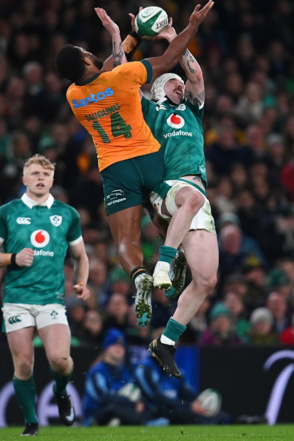 Filipo Daugunu of Australia jumps for the ball with Mack Hansen.