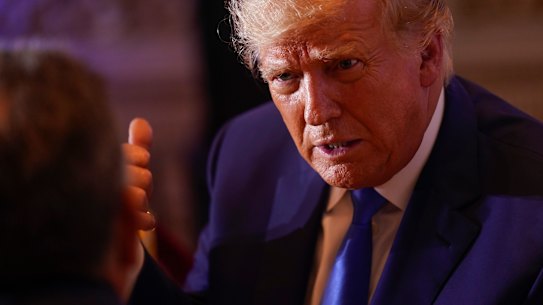 Not mad at all: Former president Donald Trump talks with people at Mar-a-lago on Election Day.