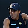 MELBOURNE, AUSTRALIA - JANUARY 14: Rinky Hijikata of Australia plays a backhand against Mitchell Krueger of the United States in the Men’s Singles First Round match during day three of the 2025 Australian Open at Melbourne Park on January 14, 2025 in Melbourne, Australia. (Photo by Quinn Rooney/Getty Images)