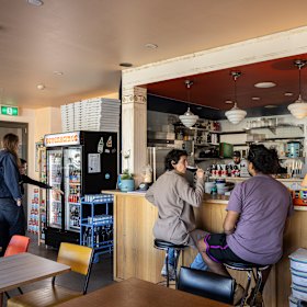 The “beveraginos” drinks fridge (left) and timber columns.