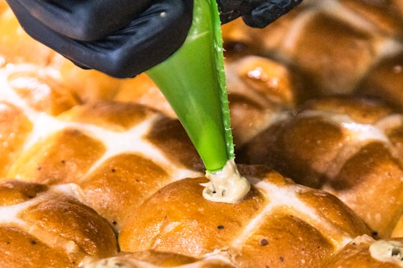 Hand-piping the batches of pistachio hot cross buns at Pasticceria Papa in Five Dock.