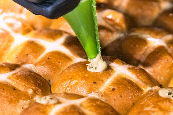 Hand-piping the batches of pistachio hot cross buns at Pasticceria Papa in Five Dock.