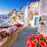 Skyline of Oia, traditional white architecture with windmills, Greek village of Santorini, Greece. 
