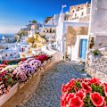Skyline of Oia, traditional white architecture with windmills, Greek village of Santorini, Greece. 
