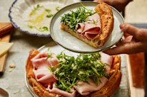 Dutch baby pancake with mortadella and rocket.