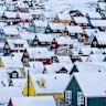 Multi-coloured, snow-covered houses huddled in the diminutive Greenlandic capital of Nuuk.