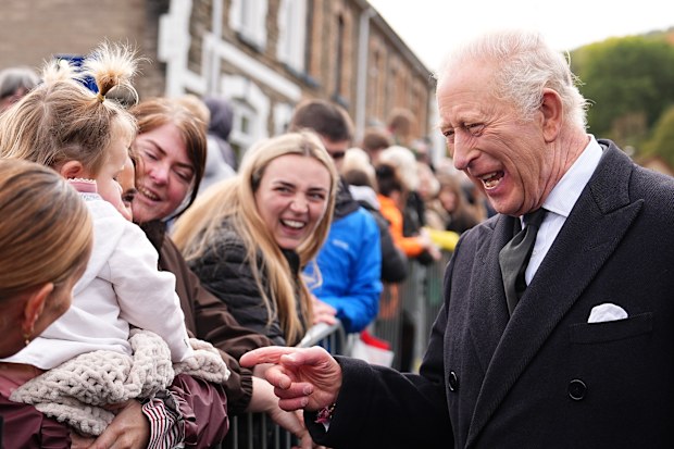 Britain’s King Charles III speaks to members of the public lining the streets outside Aberfan Memorial Garden in Aberfan, Wales, Wednesday, Oct. 21, 2026 