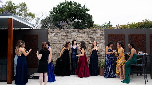 Our Lady of Mercy College Parramatta students post at a pre-formal gathering with their parents.