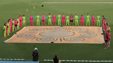 Sixers and Thunder players take part in a barefoot circle before last week's Sydney Smash in Canberra.