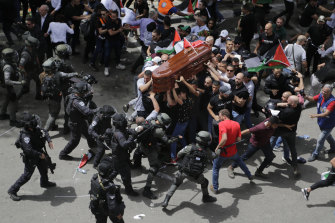 Israeli police beat mourners as they carry the casket of slain Al Jazeera veteran journalist Shireen Abu Akleh during her funeral in east Jerusalem.