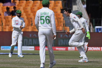 Pakistan’s Naseem Shah, right, celebrates after taking the wicket of Australia’s Nathan Lyon.