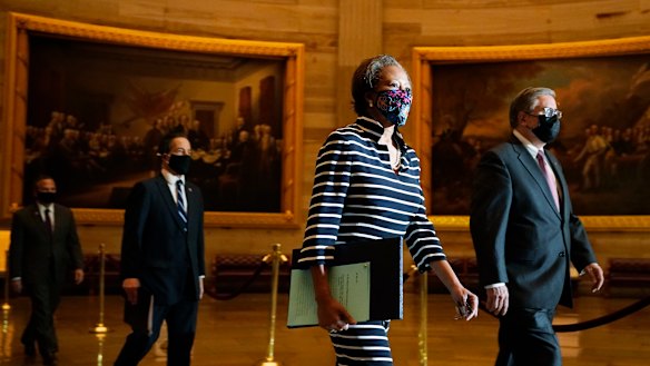 Clerk of the House Cheryl Johnson along with acting House Sergeant-at-Arms Tim Blodgett, lead the Democratic House impeachment managers as they walk through Statuary Hall in the Capitol.