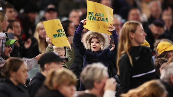 A young fan cheers for the Matildas in their friendly match against New Zealand in Canberra.