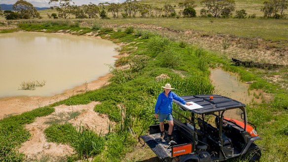 Braidwood farmer Martin Royds beside one of his first moated dams, which is starting to fill up.