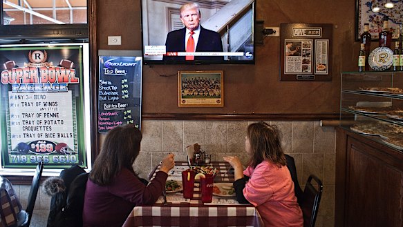Customers watch television on the day of Donald Trump's presidential inauguration, at W’s Bar and Restaurant.  New York's 11th congressional district - which encompasses all of Staten Island and a slice of south Brooklyn - is the last remaining Republican-held seat in New York City.