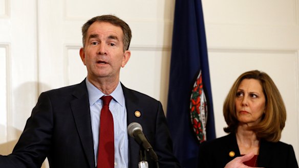 Virginia Governor Ralph Northam,  accompanied by his wife, Pam, speaks during a news conference in the Governor's Mansion in Richmond on Saturday.